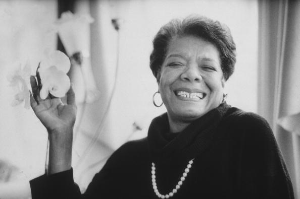 8th January 1993: Headshot portrait of African-American author Maya Angelou wearing black sweater with a pearl necklace, smiling and holding flowers in one hand. (Photo by Stephen Matteson Jr/New York Times Co./Getty Images) Click on the image to be taken to the websource.
